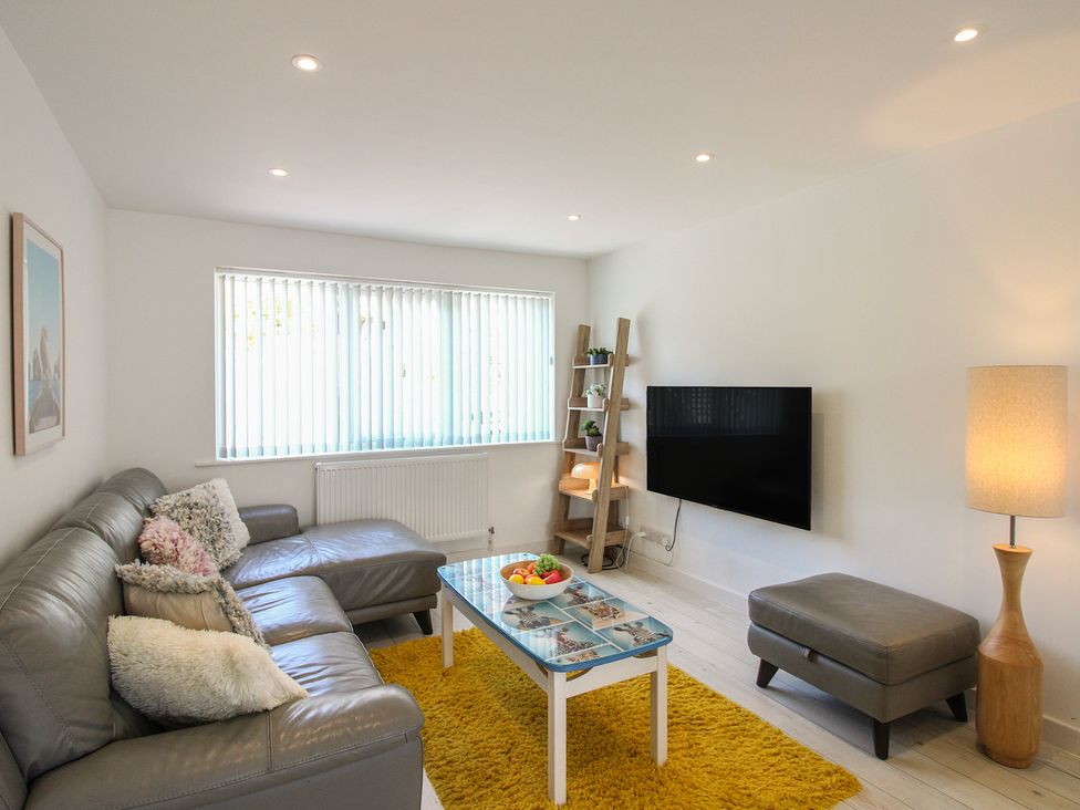 A living room with furniture including a sofa and television at Little Starboard in Kingsbridge