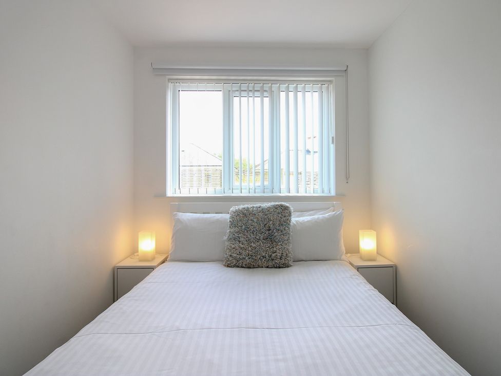 A bedroom with a bed and window at Little Starboard in Kingsbridge