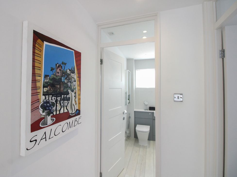 A bathroom with a toilet and sink at Little Starboard in Kingsbridge
