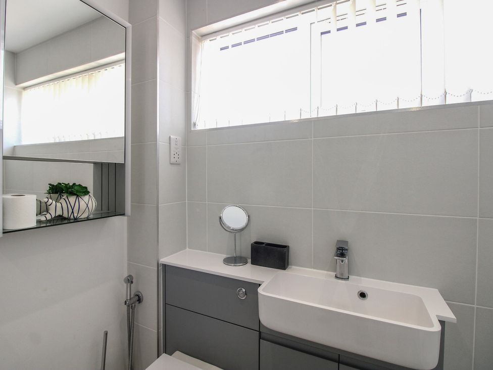 A bathroom with a sink and mirror at Little Starboard in Kingsbridge