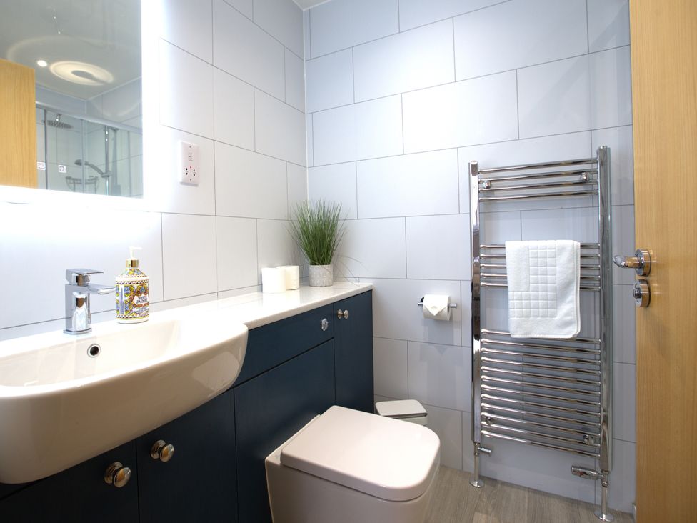 A bathroom with a sink and toilet at Honeybee Cottage in Penruddock