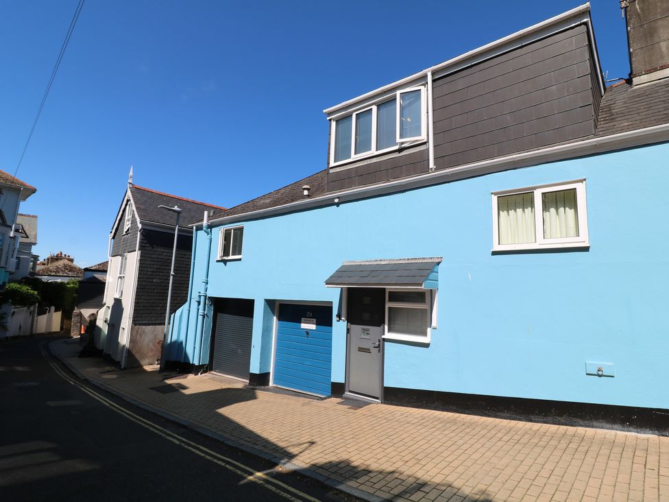 A building with a blue exterior and garages at 21 Above Town Dartmouth