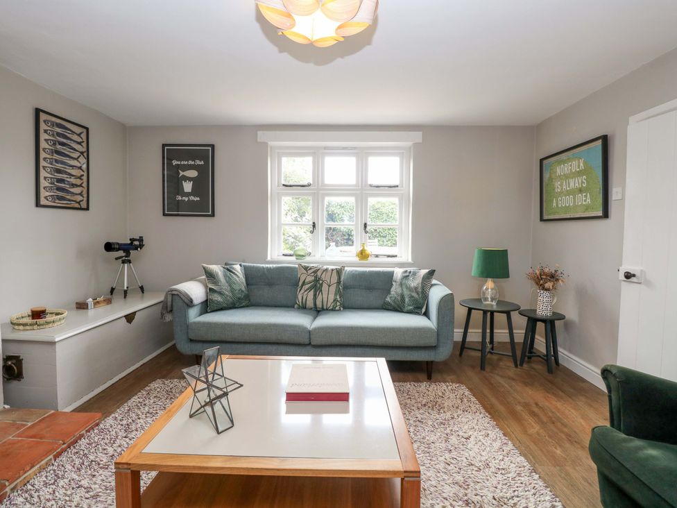 A living room with a sofa and table at The Mallows in Walsingham