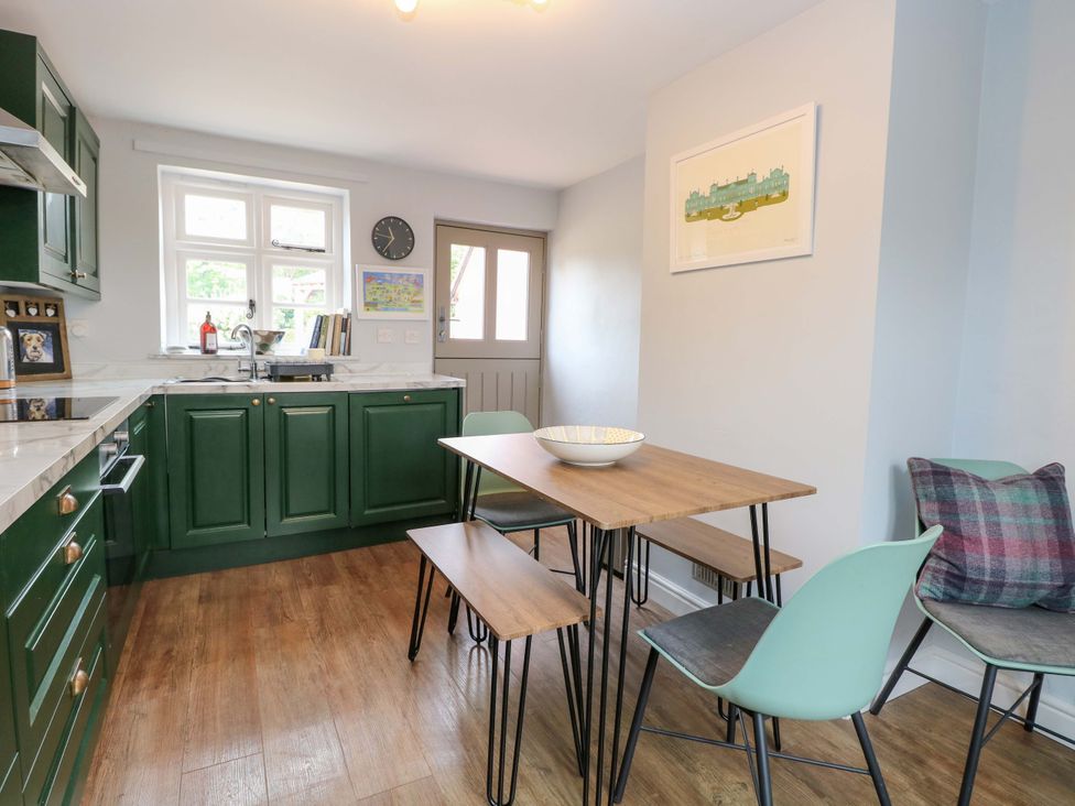 A kitchen with a table and chairs at The Mallows in Walsingham