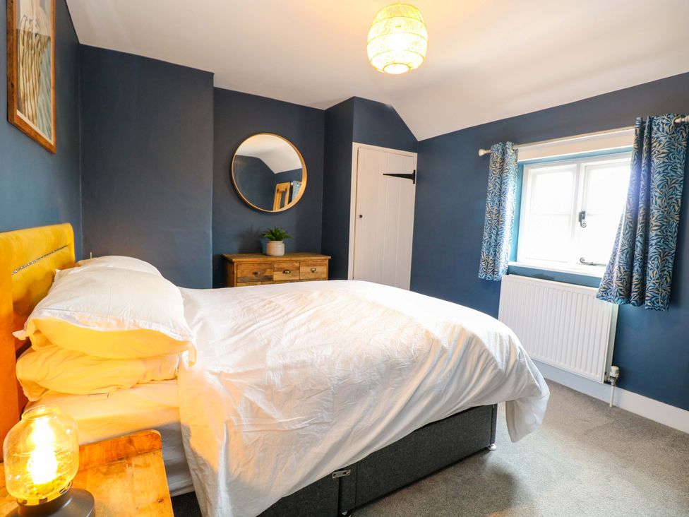 A bedroom with a bed and furniture at The Mallows in Walsingham