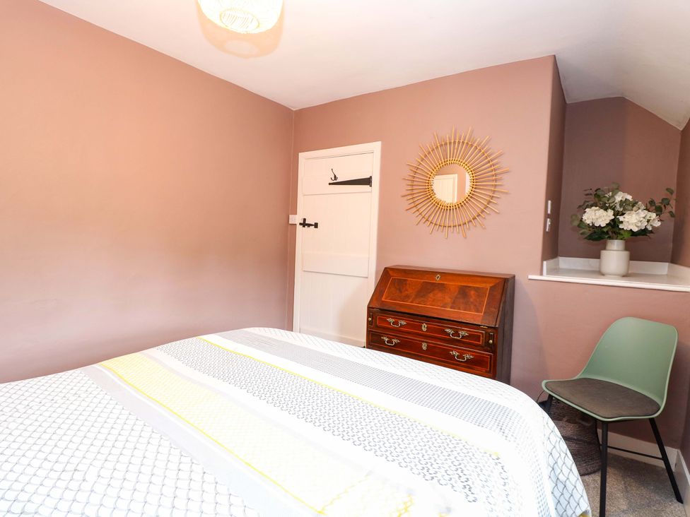A bedroom with a bed and dressing table at The Mallows in Walsingham