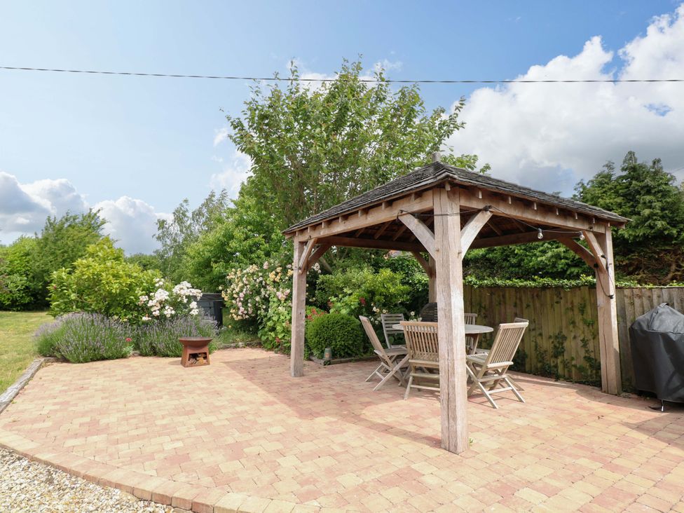 A gazebo with a table and chairs in the garden at The Mallows Walsingham