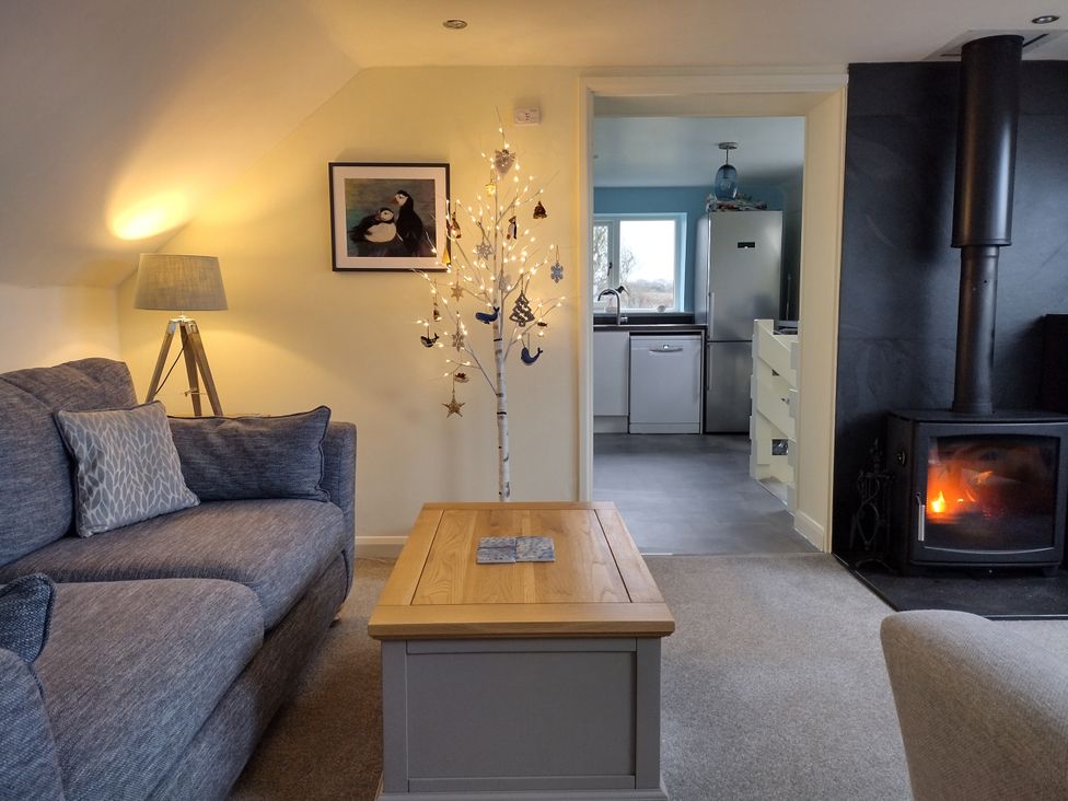 A living room with a sofa and coffee table at Coast View in Hartland