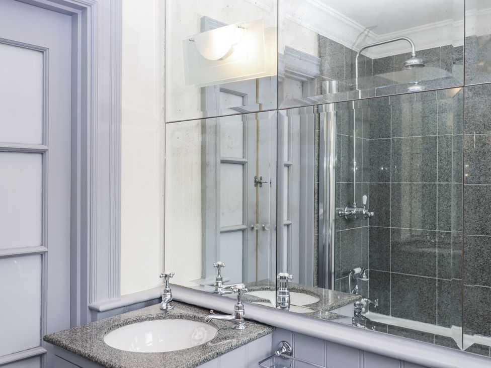 A bathroom with a sink and shower at Lion House in Moretonhampstead