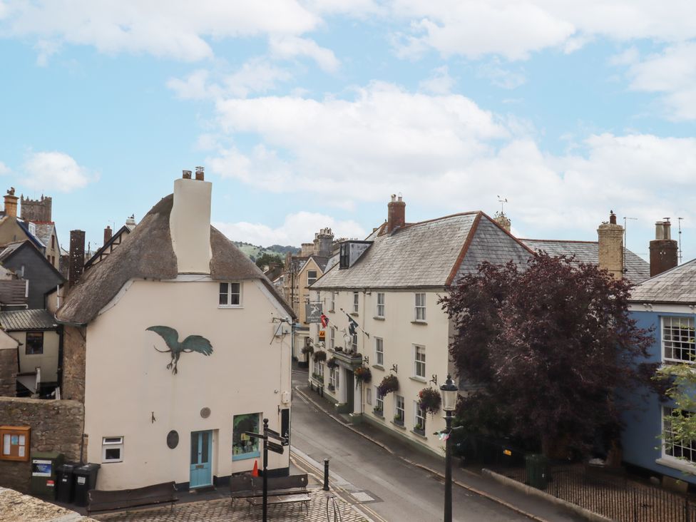 A view of houses and a tree on a street at Lion House in Moretonhampstead