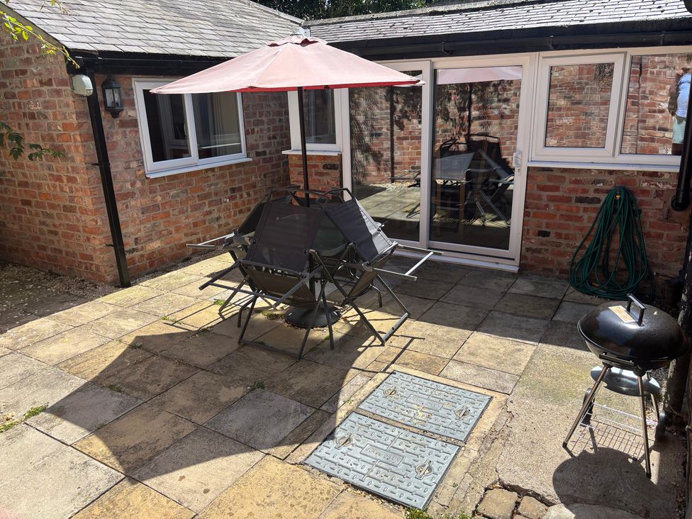 An outdoor area with a table and chairs at Claire Cottage Gateforth near Hambleton, North Yorkshire