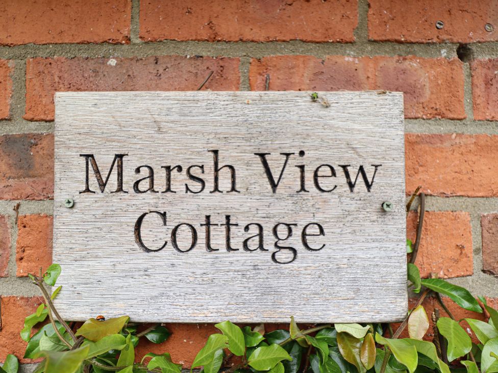 A sign reading Marsh View Cottage on a brick wall in Wainfleet All Saints