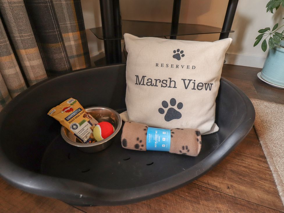 A dog bed with a reserved cushion and dog toys at Marsh View Cottage in Wainfleet All Saints