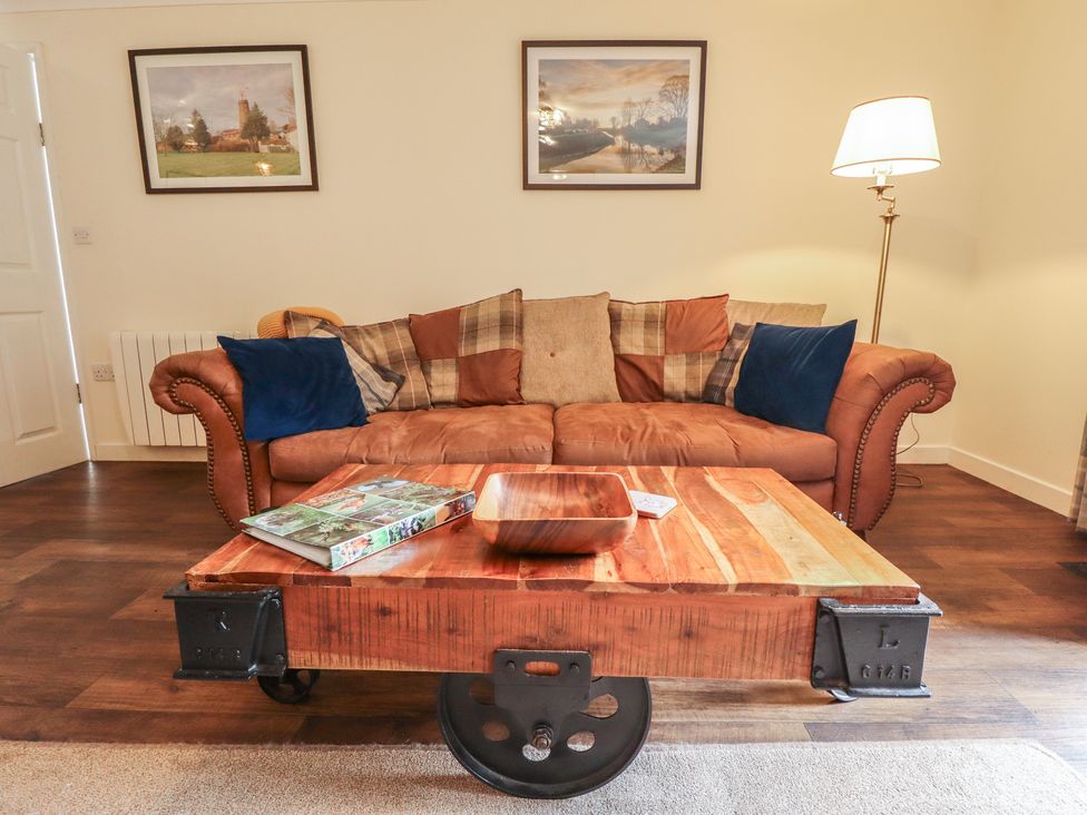 A living room with a sofa and coffee table at Marsh View Cottage in Wainfleet All Saints