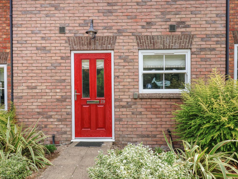 A red front door with a window next to it at Buck Place The Bay - Filey