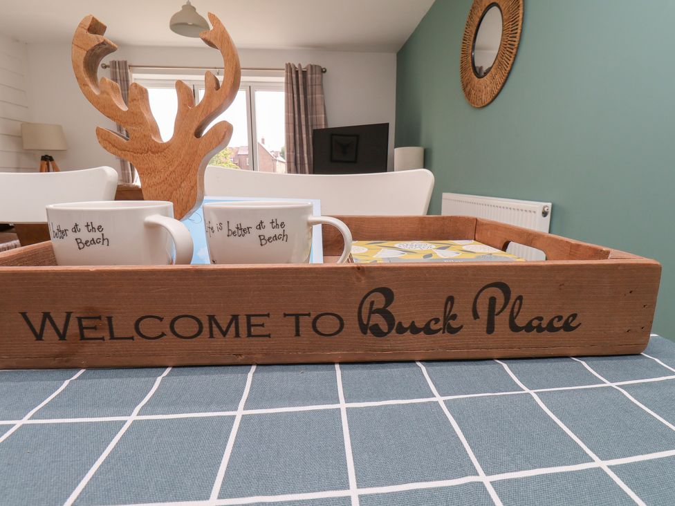 A wooden tray with coffee cups and decorative items at Buck Place The Bay - Filey