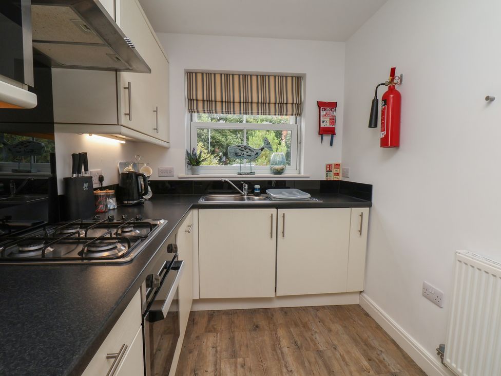 A kitchen with a sink and gas hob at Buck Place The Bay - Filey