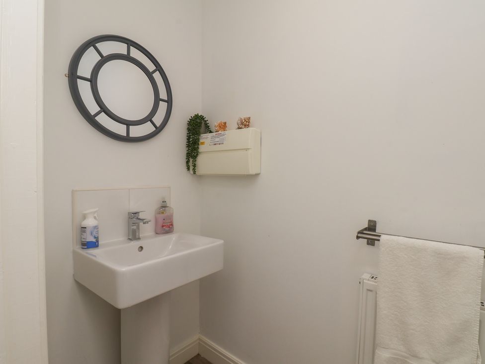 A bathroom with a sink and mirror at Buck Place The Bay - Filey