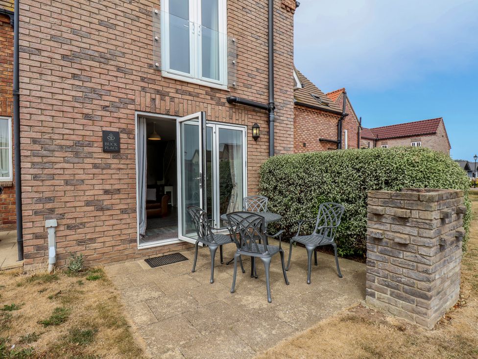An outdoor area with a table and chairs at Buck Place The Bay - Filey