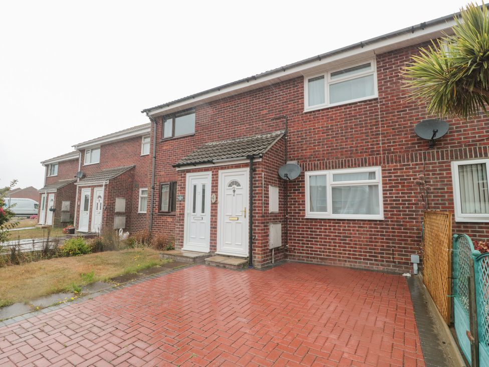 A house with a brick facade and a front door in Weymouth at Jay Cottage