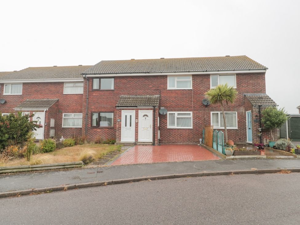 A house with a driveway and garden at Jay Cottage in Weymouth