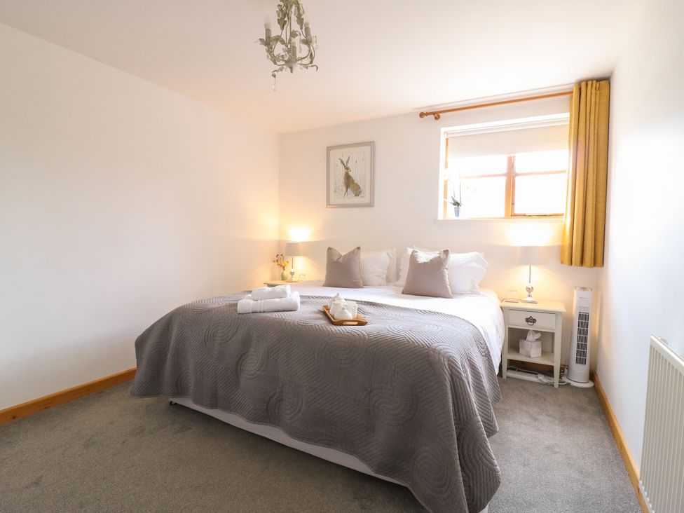 A bedroom with a bed and bedside table at BB House Roxhill Manor Farm