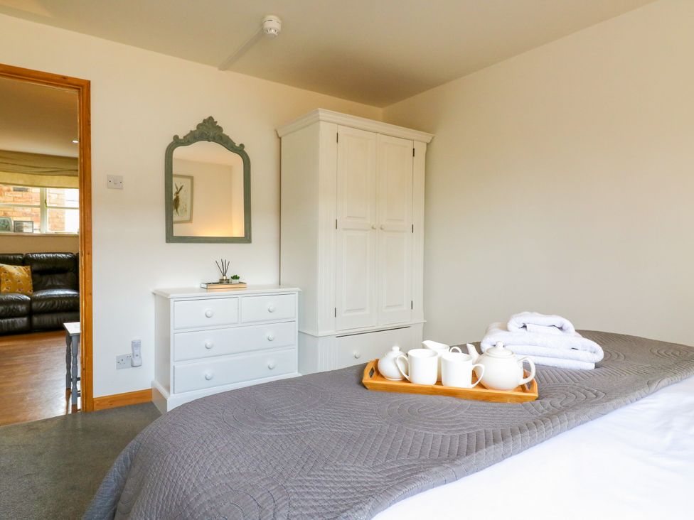 A bedroom with a bed and dresser at BB House Roxhill Manor Farm