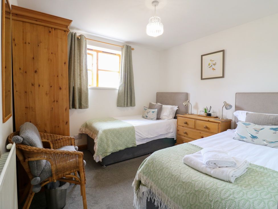 A bedroom with two beds and a dresser at BB House Roxhill Manor Farm