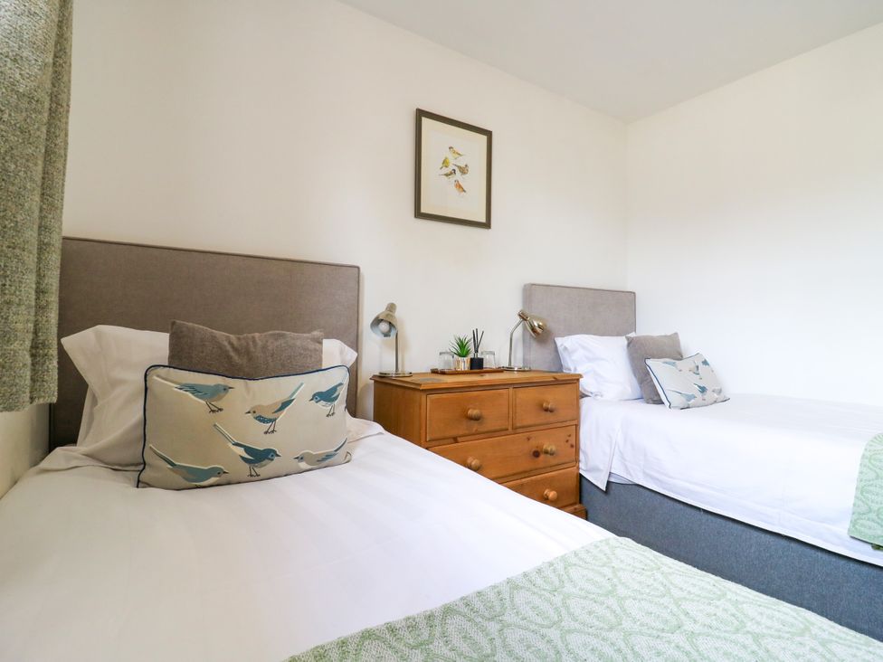 A bedroom with two beds and a dresser at BB House Roxhill Manor Farm
