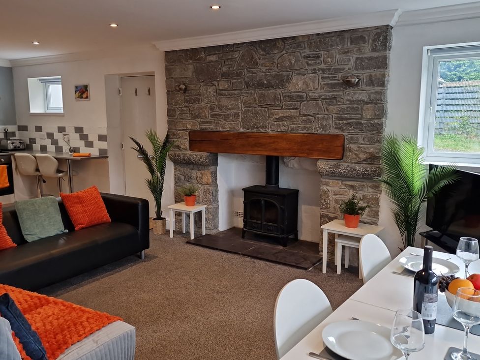 A living room with a fireplace and dining area at Bryn in Bethesda
