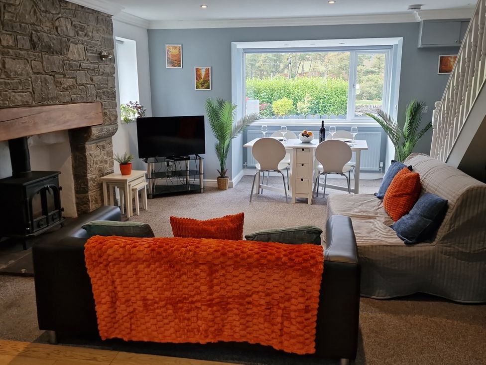 A living room with a sofa and dining area at Bryn in Bethesda