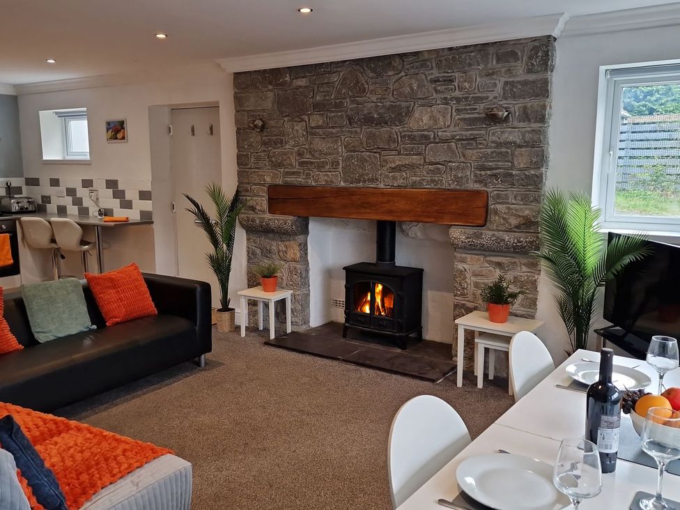 A living room with a fireplace and dining area at Bryn in Bethesda