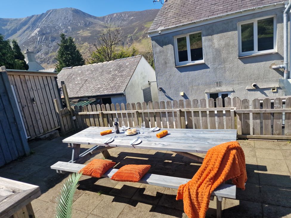 A picnic table with tableware and an orange blanket at Bryn in Bethesda