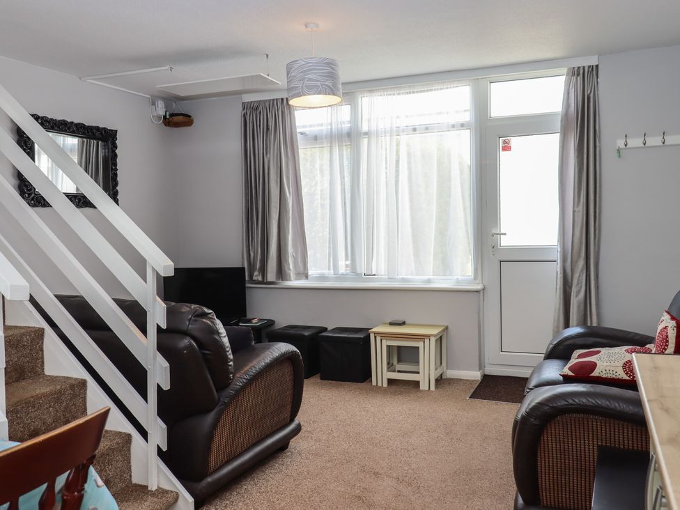 A living room with a sofa and window at Turtle Chalet in Dawlish Warren