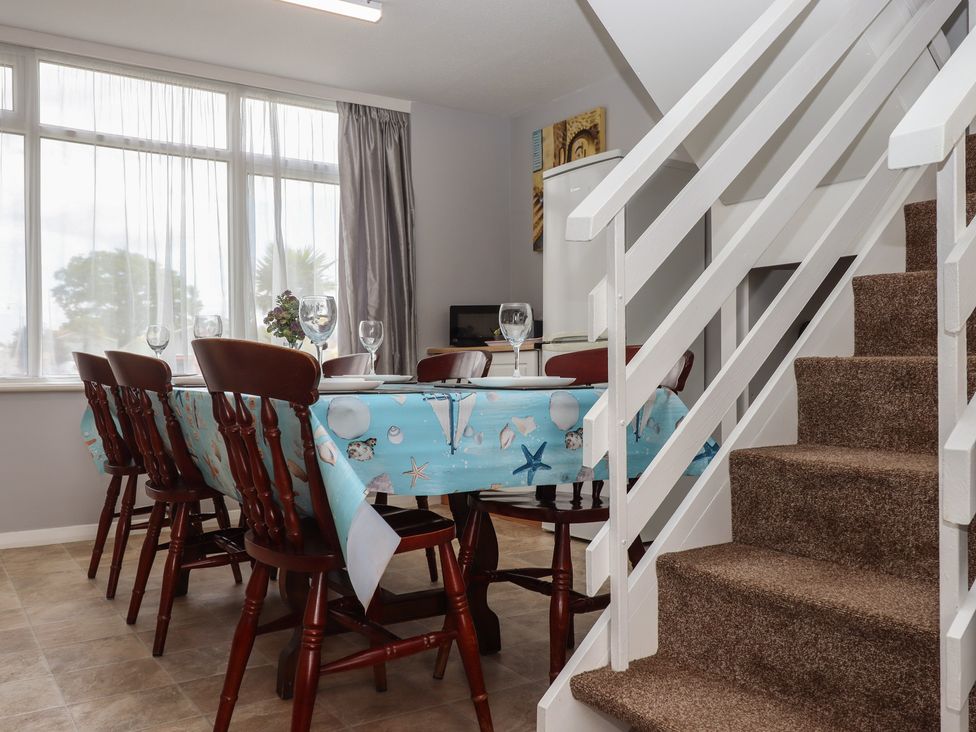 A dining room with a table and chairs at Turtle Chalet in Dawlish Warren