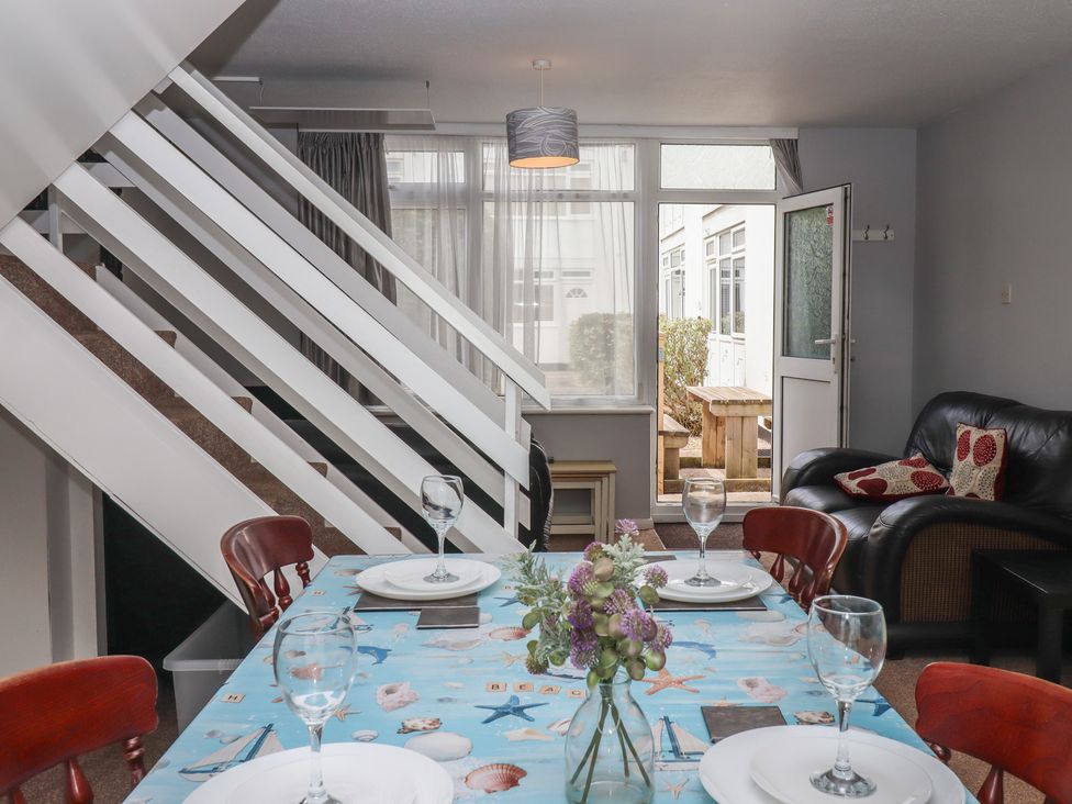 A dining area with a table set for a meal at Turtle Chalet in Dawlish Warren