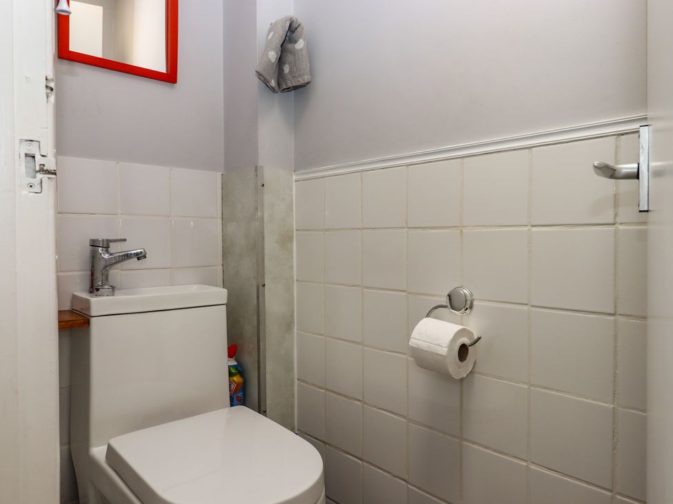 A bathroom with a toilet and sink at Turtle Chalet in Dawlish Warren