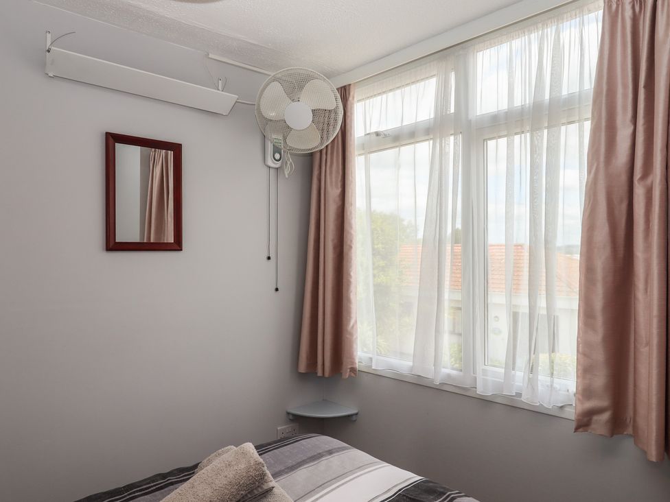 A bedroom with a bed and window at Turtle Chalet in Dawlish Warren