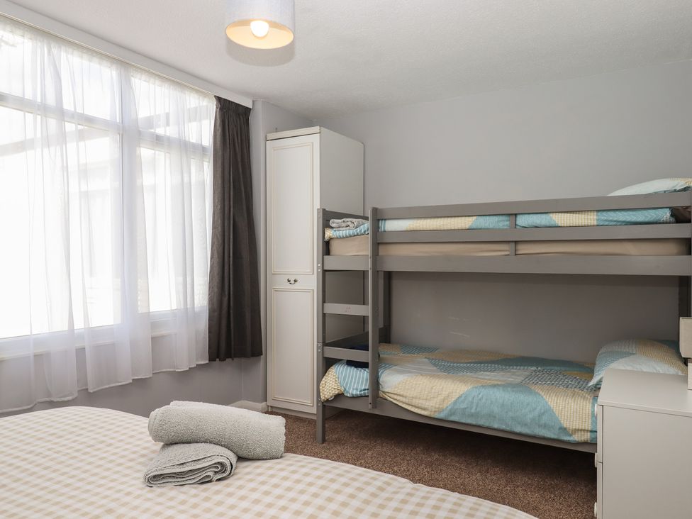 A bedroom with a bunk bed and a double bed at Turtle Chalet in Dawlish Warren
