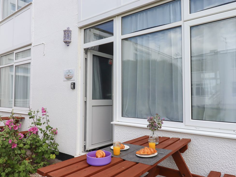 An outdoor seating area with food and drinks at Dolphin Chalet Dawlish Warren