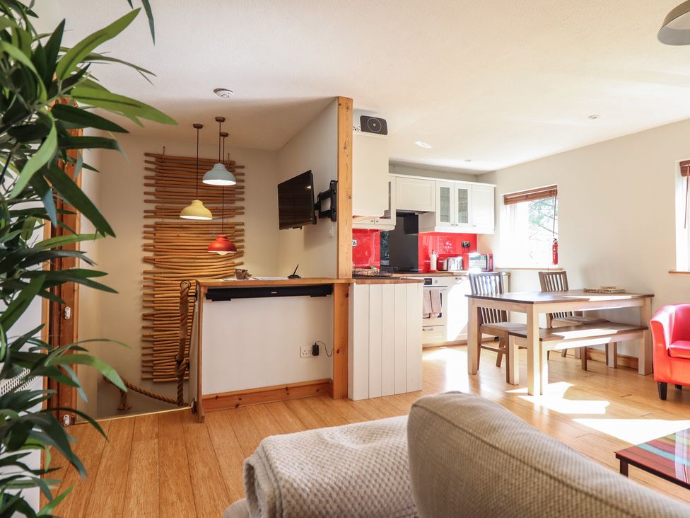 A kitchen with dining table and chairs at Redwood in Harlech