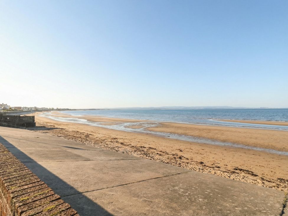 A beach with sand and water at Breaking Waves in Burnham-On-Sea