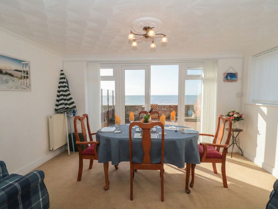 A dining room with a table and chairs at Breaking Waves in Burnham-On-Sea