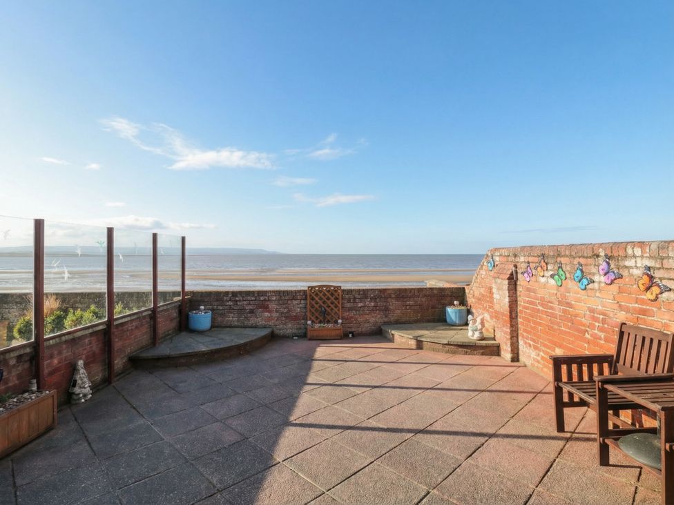 An outdoor patio with a view of water at Breaking Waves in Burnham-On-Sea