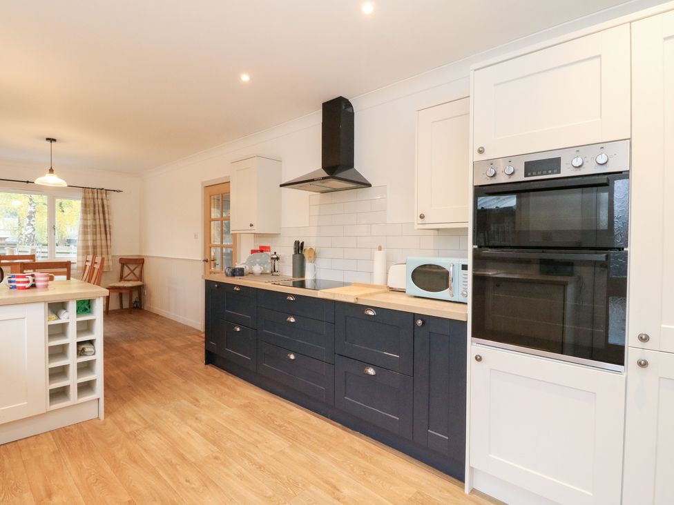 A kitchen with appliances and cabinets at Beechwood Cottage in Blair Atholl