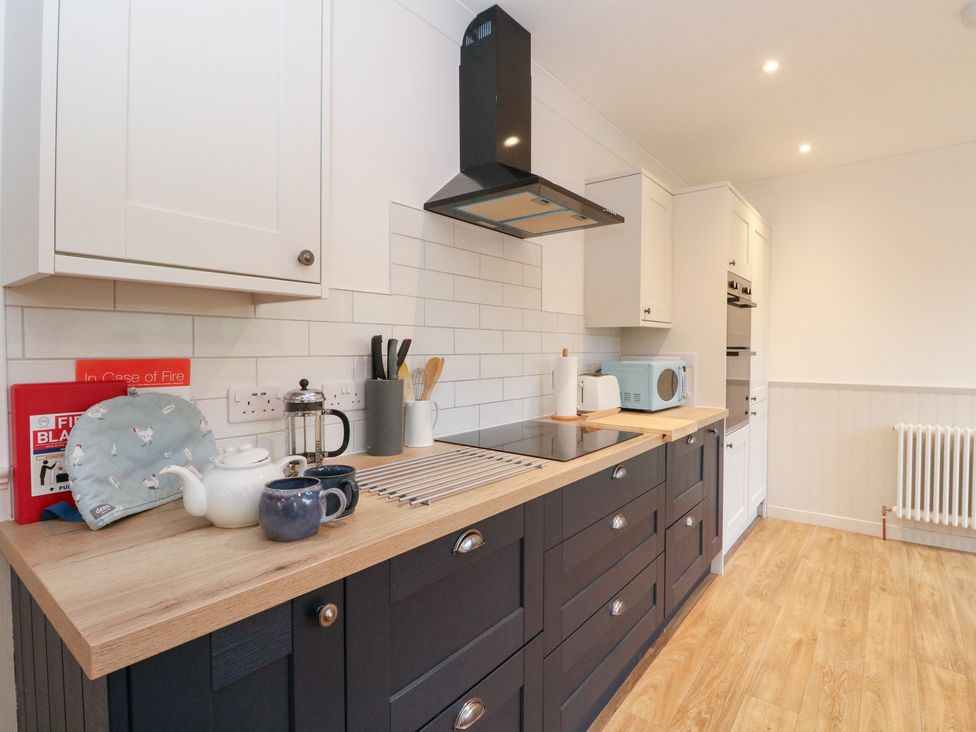 A kitchen with cabinets and appliances at Beechwood Cottage in Blair Atholl