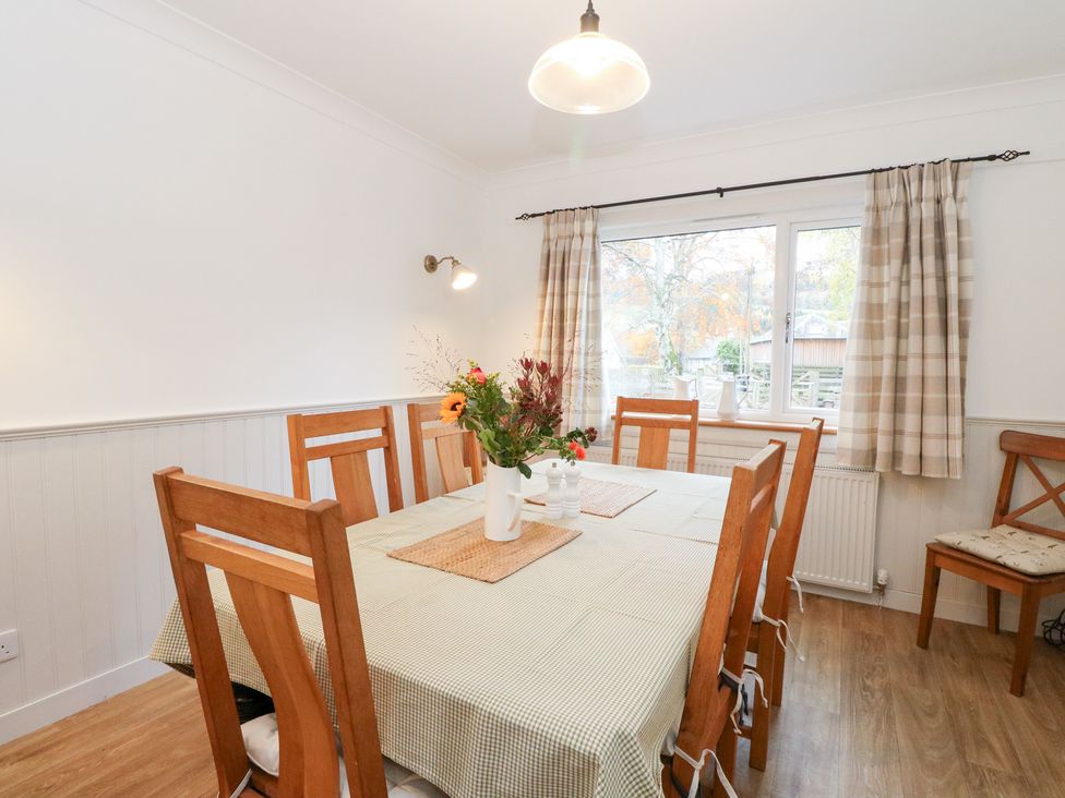 A dining room with a table and chairs at Beechwood Cottage in Blair Atholl