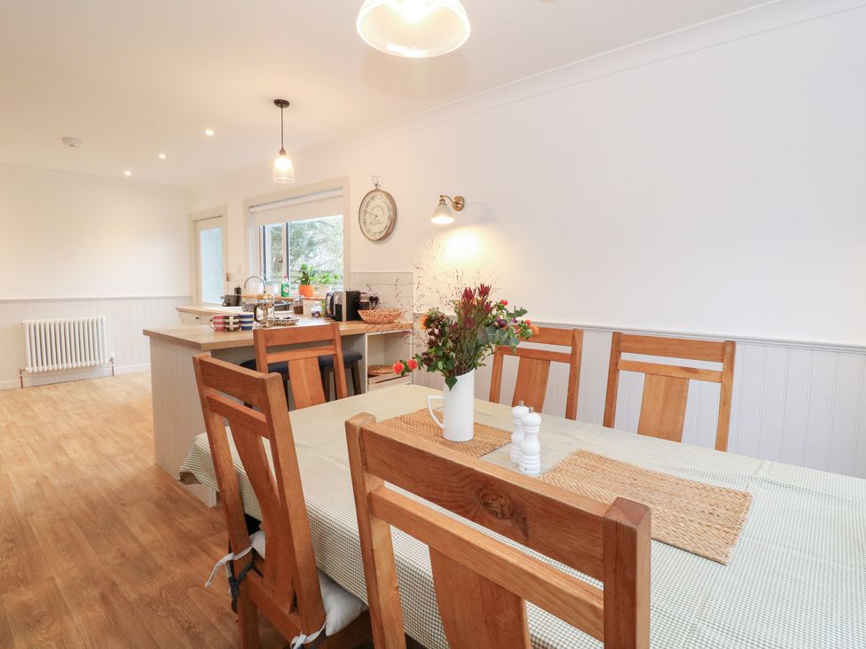 A dining room with a wooden table and chairs at Beechwood Cottage Blair Atholl