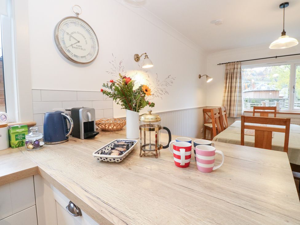 A kitchen with a kettle coffee maker and cups at Beechwood Cottage in Blair Atholl