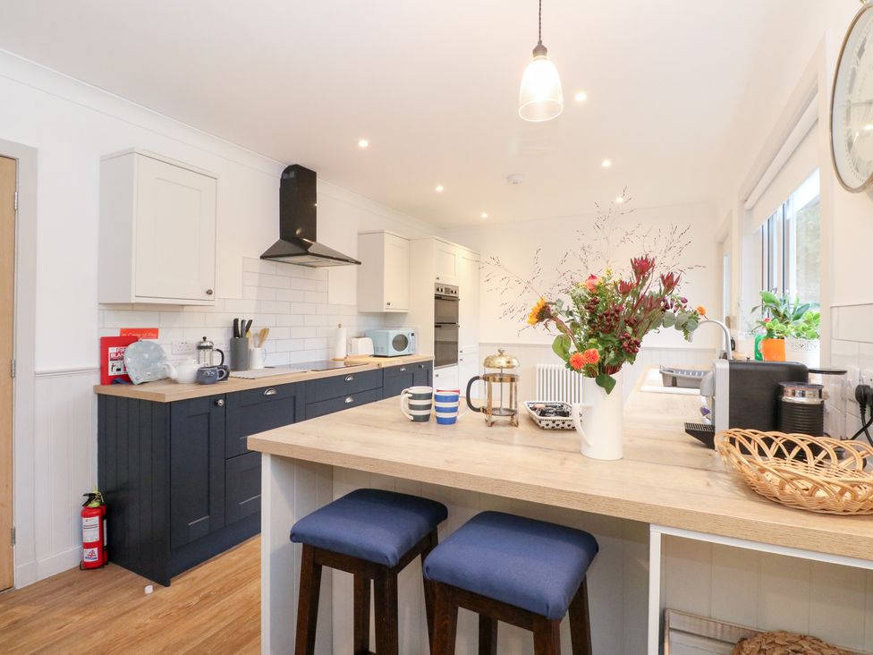 A kitchen with a counter and appliances at Beechwood Cottage in Blair Atholl